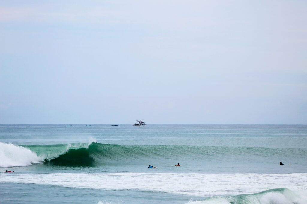 A long left-hand surf break at El Barco in Salinas surf, Ecuador surf, featuring vibrant blue water and clear blue skies