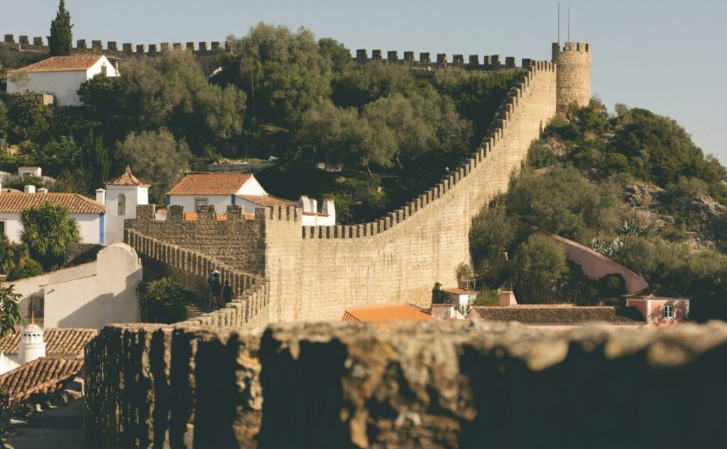 A picturesque view of the rolling stone walls of Óbidos Castle