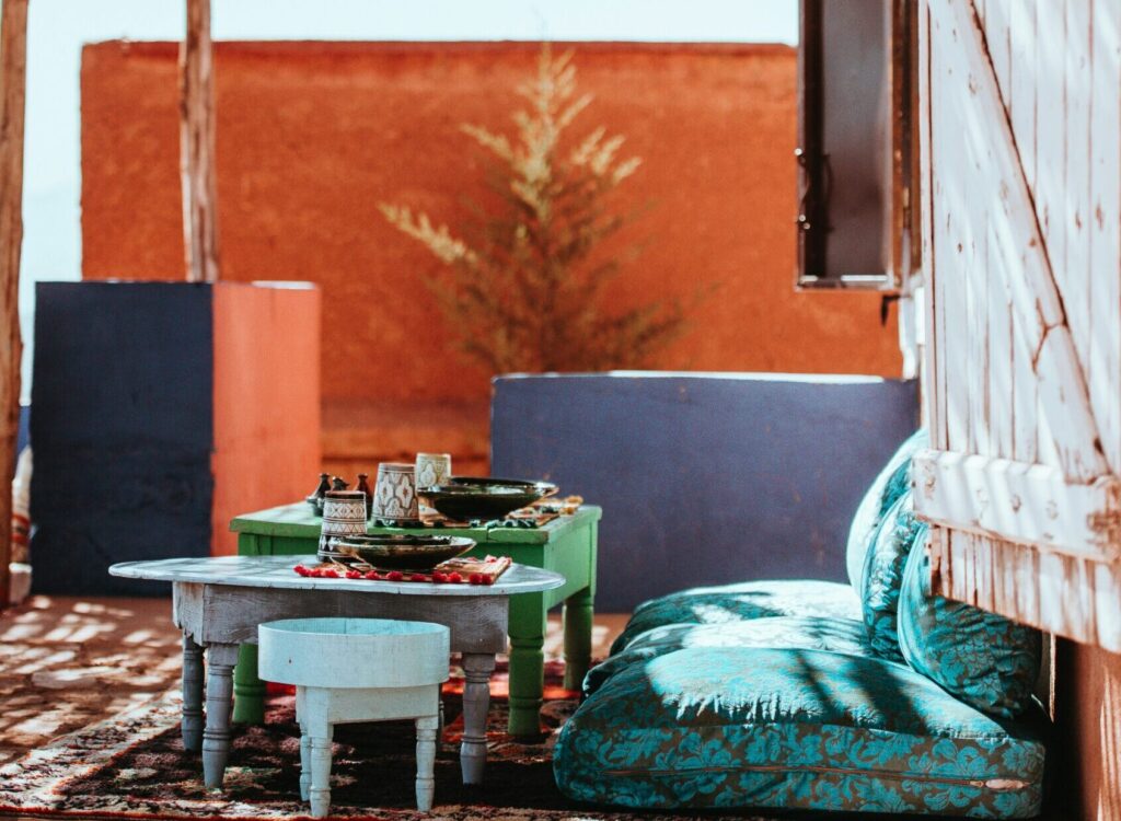 A vibrant Moroccan meal set on the ground, featuring colorful decor and a variety of delicious dishes