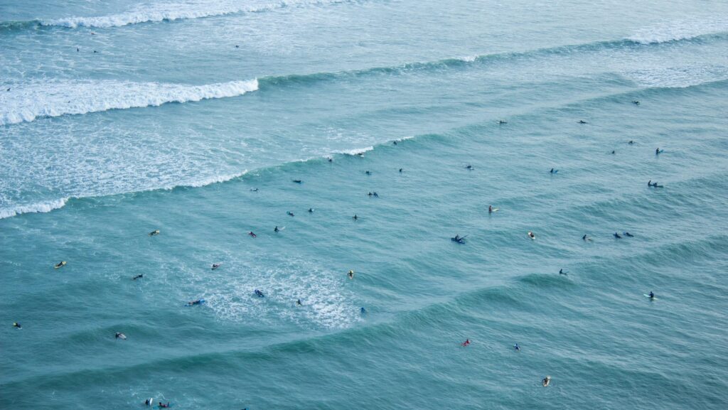 Many people surfing at Waikiki Beach, Miraflores surf in Peru surf