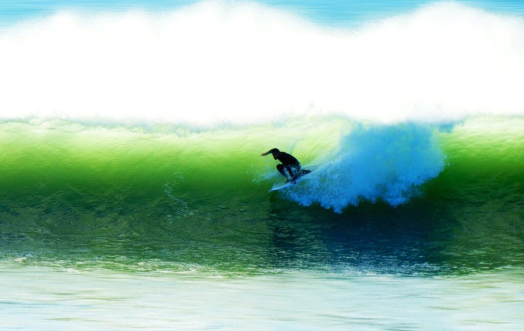 A surfer pulls into the green colored barrel of a right-hand wave in Les Sables-d'Olonne Surf, France