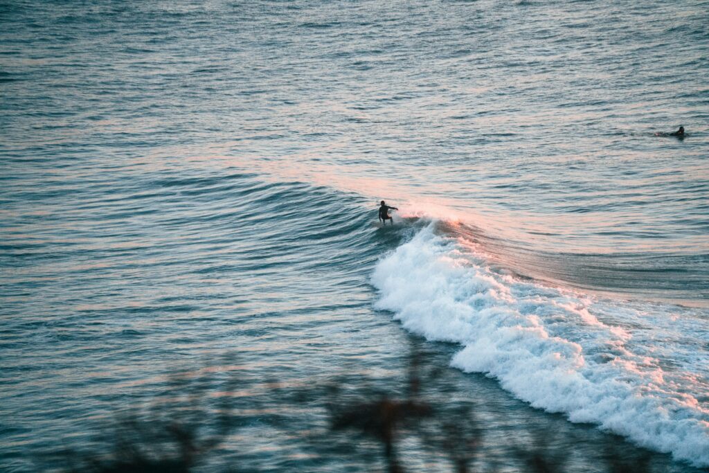 Surfer riding a rolling right-hand wave at Ribeira d'Ilhas - Ericeira surf