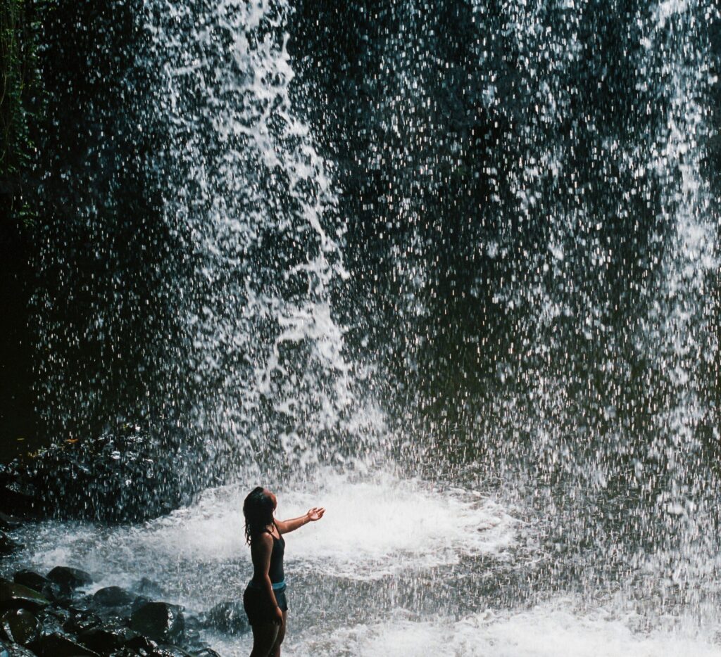 Waterfall in Byron Bay Hinterland with a girl holding out her hand