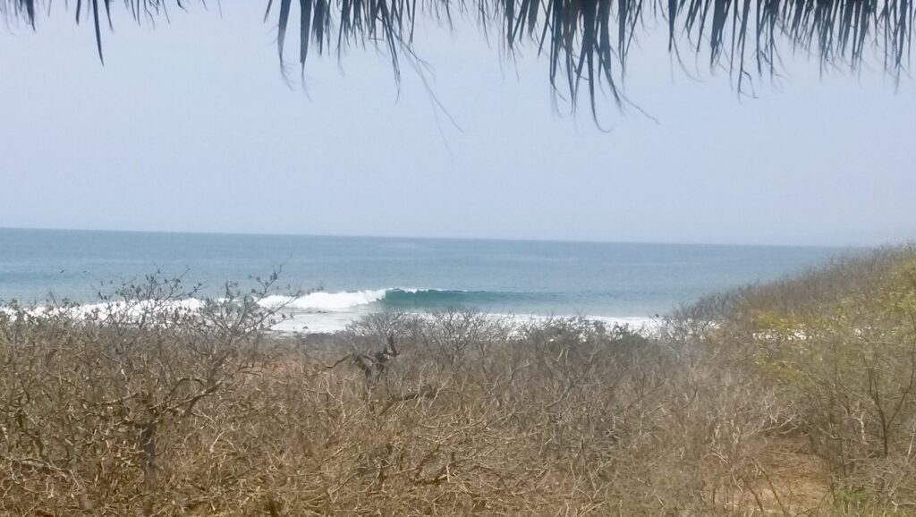 Troncones Surf Point breaking as a left-hand point break, with clear skies and crisp water, empty of surfers