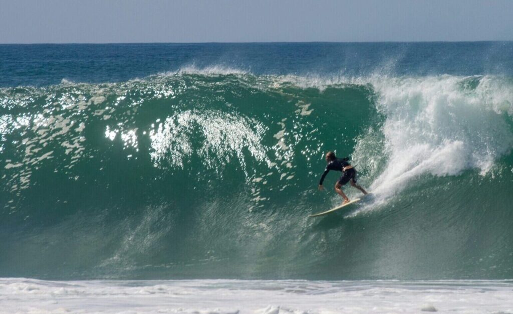 A surfer pulling into a perfect barreling wave at Playa Zicatela, Puerto Escondido surf, Mexico