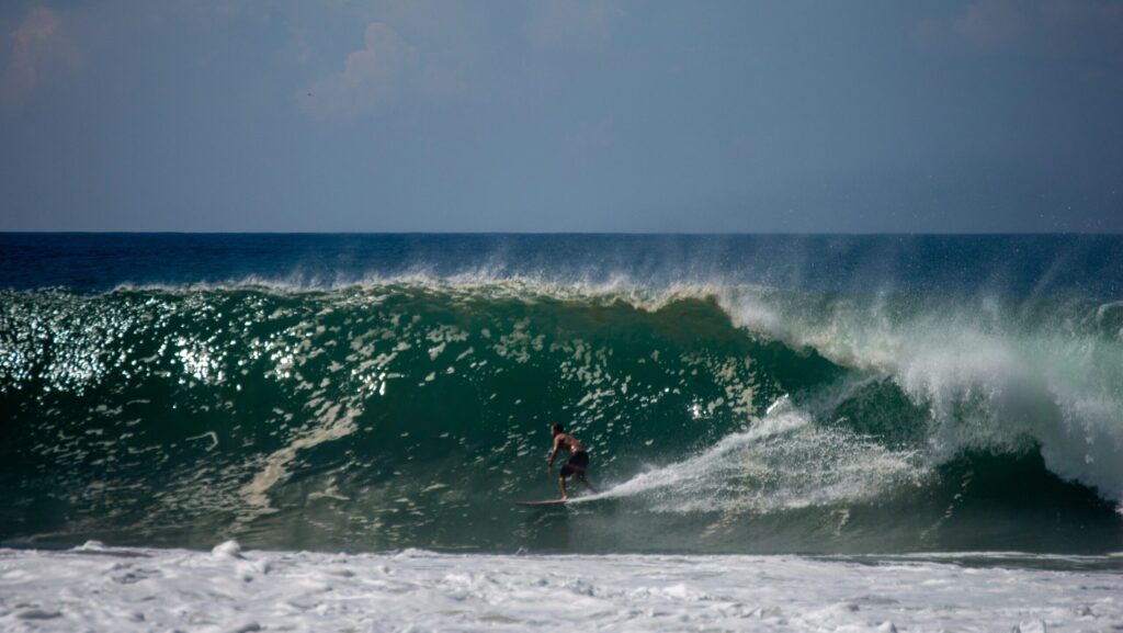 A surfer riding a perfect right-hand wave at Playa Zicatela, Puerto Escondido surf, Mexico surf