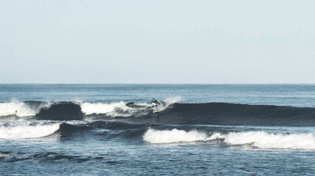 A surfer pulling a backside turn on a left-hand point wave at La Saladita surf, Mexico