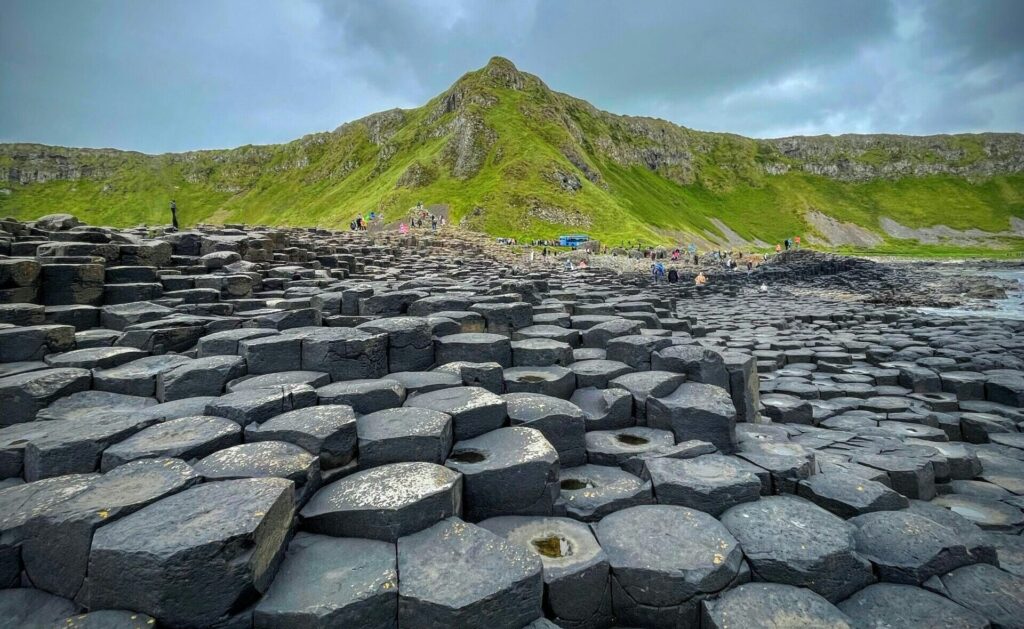 The rock formation of the Giant’s Causeway in Northern Ireland, with grassy cliffs in the background