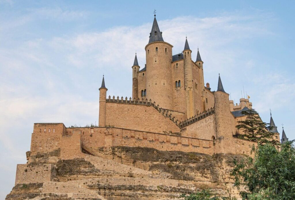 View of the Alcázar in Seville, showcasing the castle against clear blue skies.