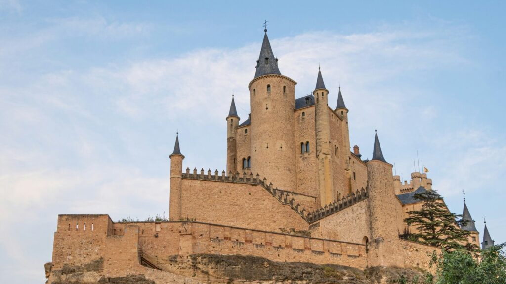View of the Alcázar in Seville, showcasing the castle against clear blue skies.