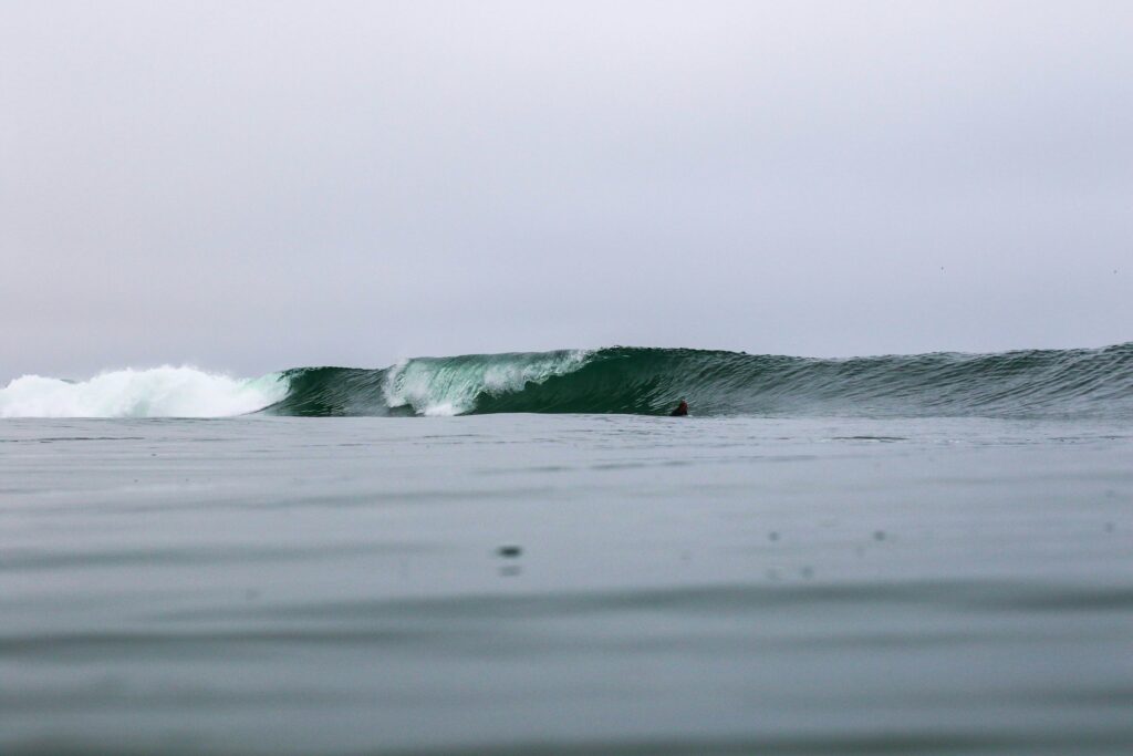 Water view of a perfect left-hand barreling wave at Desert Point, Indonesia