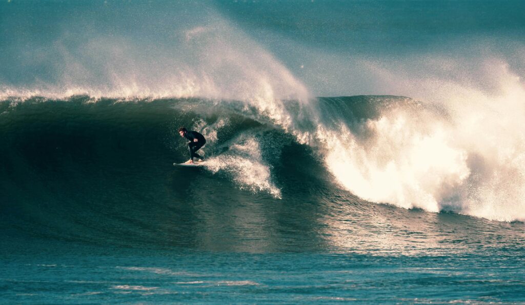 A view of a large right-hand wave at Croyde Bay in United Kingdom Surf, looking down the line with hopes of a barrel