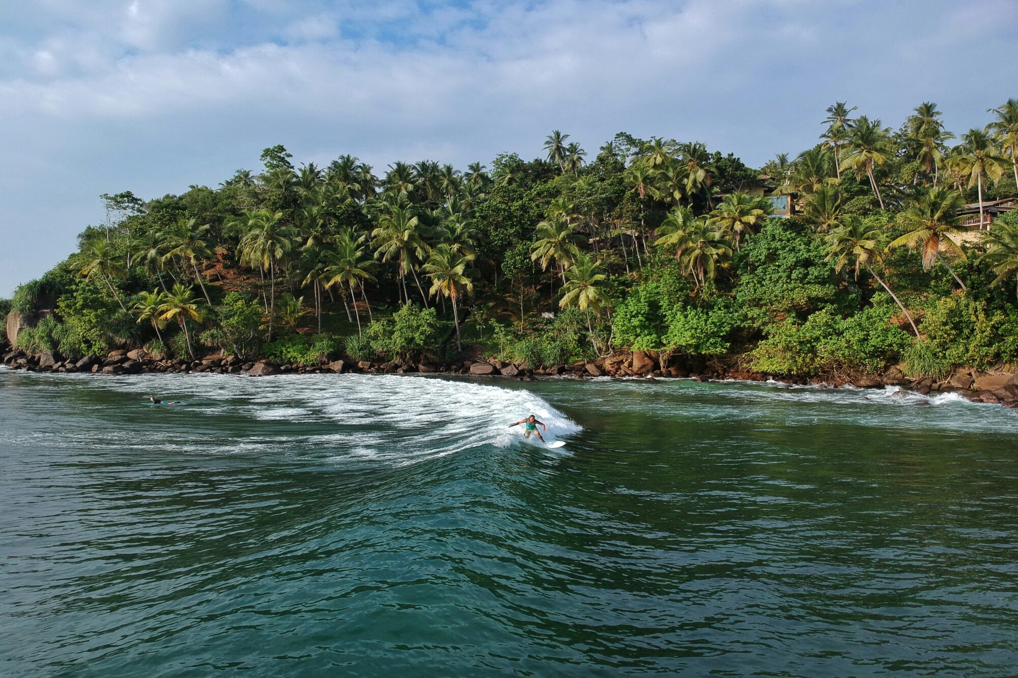 A surfer in Weligama surf at Mirissa Point Break Sri Lanka