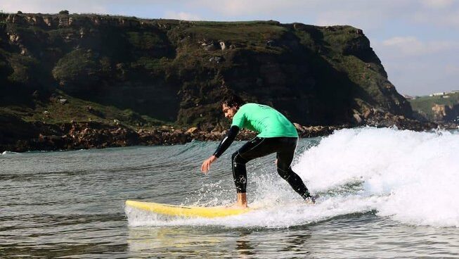 A surfer learning how to surf in Suances Surf with Bio Surf Camp