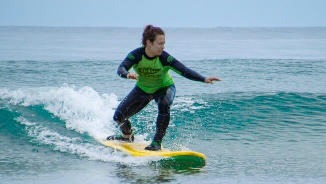 A girl learning how to surf at Suances Surf with Bio Surf Camp