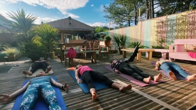 Students practicing yoga in Lacanau with Cheeky Family Surf Camp