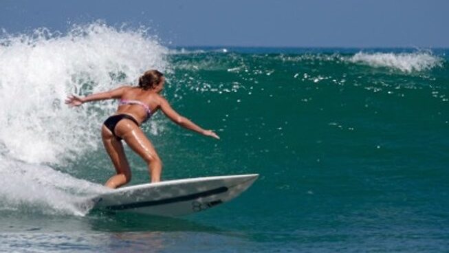 A surfer on a left hand wave in Mancora Peru with VITAVENTURA RETREATS
