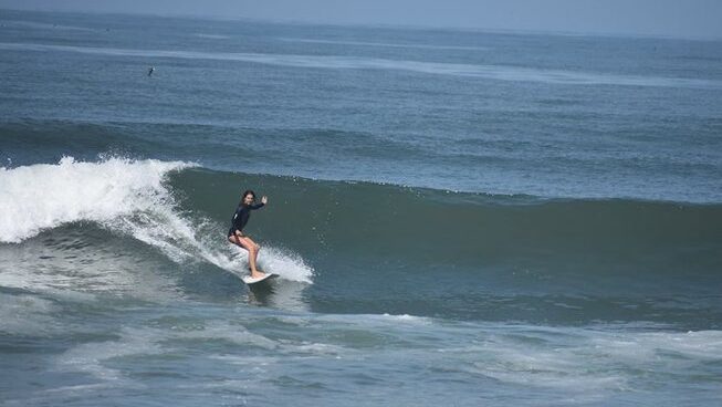 A surfer learning how to surf in Miraflores surf with Waves Surf Camp Peru