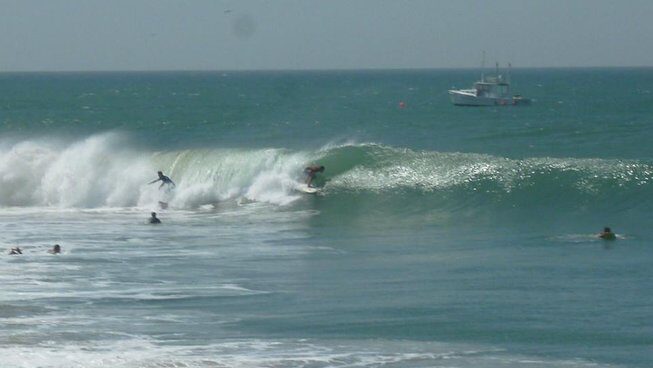 A surfer in a barrel in Peru surf with Waves Surf Camp Peru