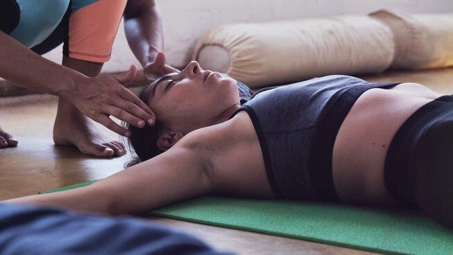 A student practicing yoga in Mancora with Wild Kite Peru Surf Camp