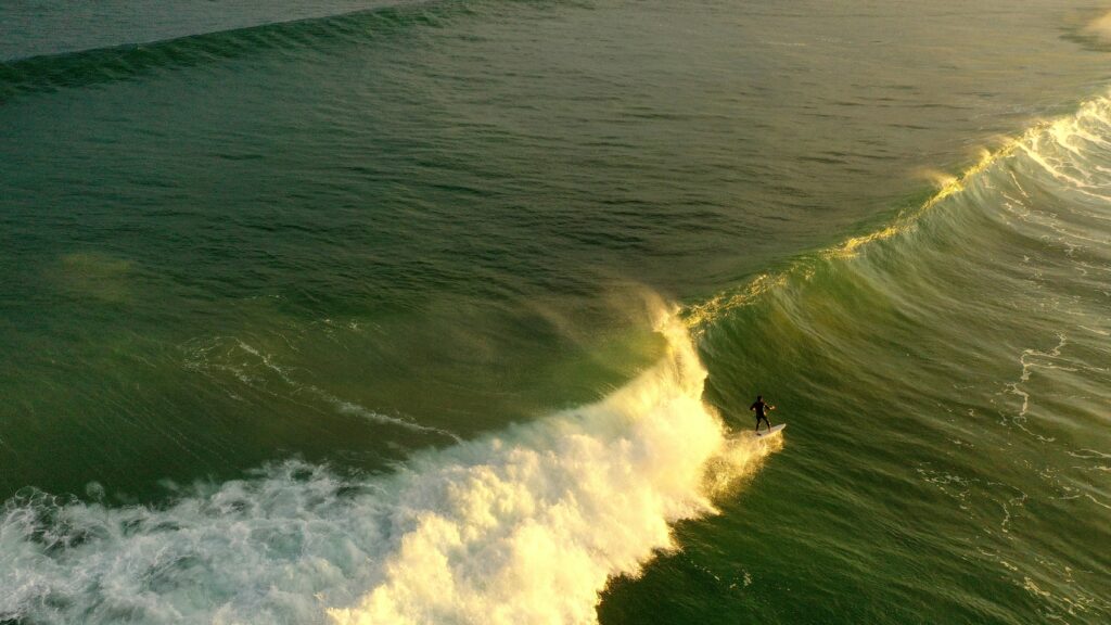 A surfer racing down the line on a big wave in Zarautz surf