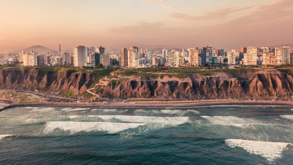 Drone shot of Miraflores surf with Lima city in the distance