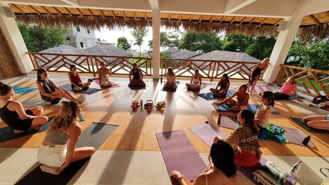 Students practicing yoga at Vikara Healing Center surf camp in Olon Ecuador