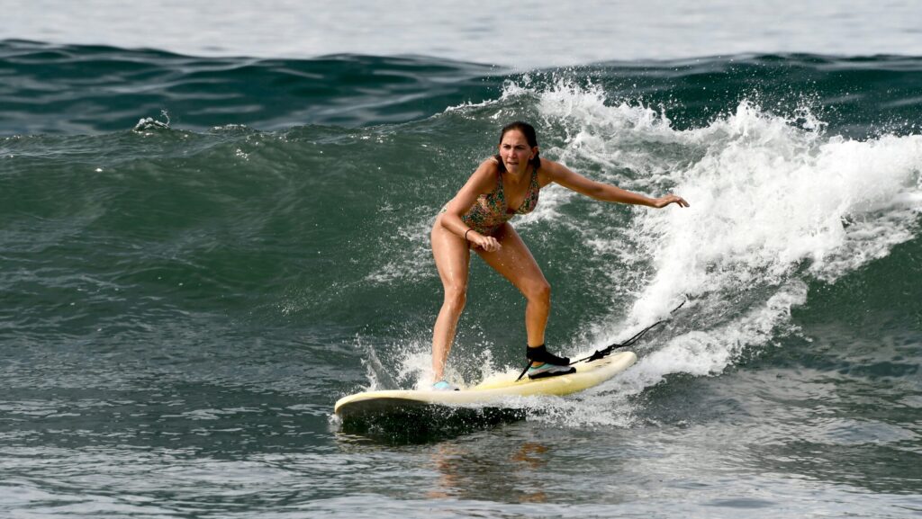 a girl surfing in Punta Mita surf with a Malibu surfboard