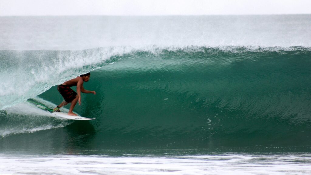 A guy in a barrel in Ayampe surf.
