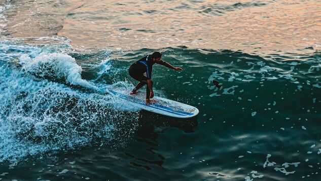 A guy surfing at Ocean beach Pier in San Diego