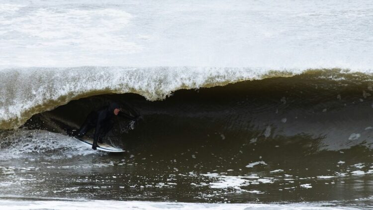 A surfer in a barrel in Rockaway Beach, New York