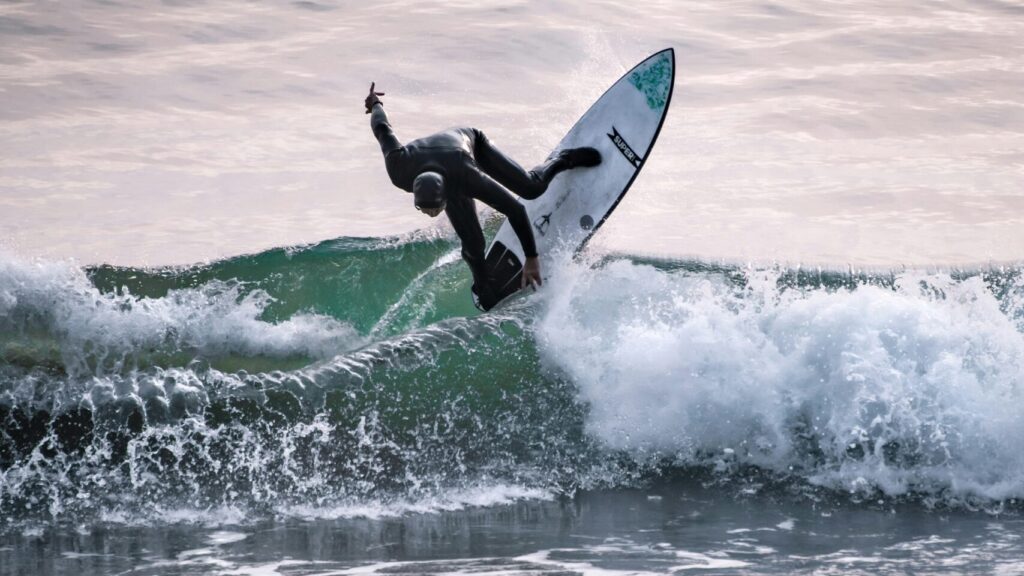 Victoria Bay surf with a surfer performing a backside cutback