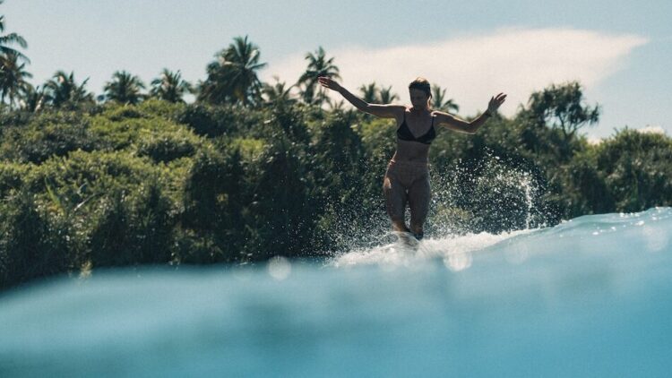 A lady dancing on water in Hiriketiya surf Beach Sri Lanka