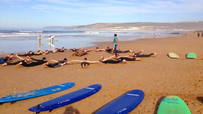 Surfers learning how to surf with Morocco surf camp for beginners at Crocro Surf Maroc surf camp
