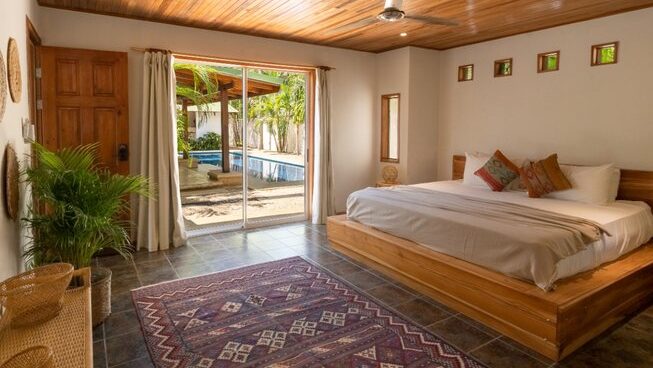 Accommodation and bed with outside view at Dreamsea Surf House surf camp Tamarindo Costa Rica