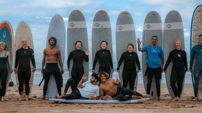 Learner surfers standing in a row at Harmony Surf Lodge Taghzout surf camp