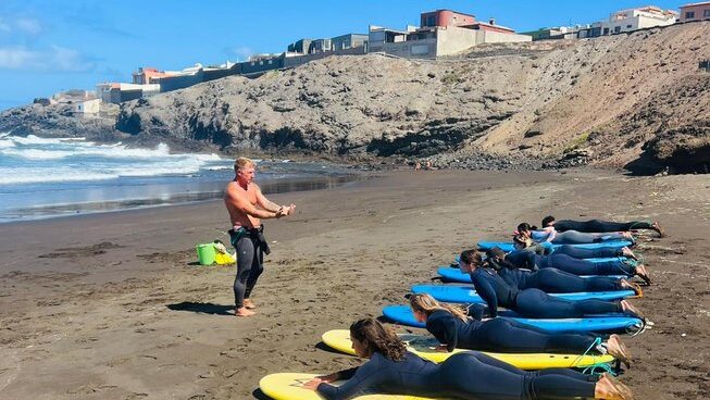 Students learning how to surf at High Voltage Adventure surf camp in Playa del Hombre