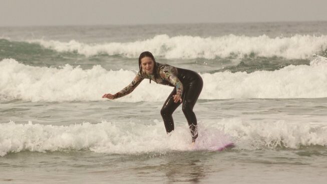 Learner surfer standing up on wave with Paddle Out Morocco surf camp Taghazout surf and yoga retreat