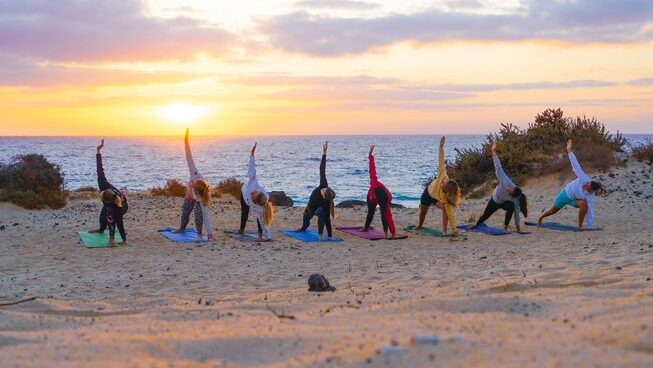 A group of girls doing yoga at Salty Chicas surf camp
