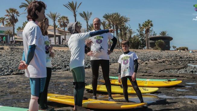 Surfers learning on the beach with Playa de las Americas surf camp with The Point Surf Club