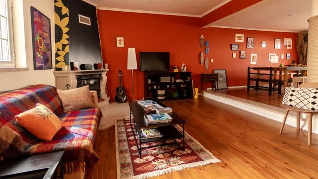 accommodation with couches and tables with bunk beds at Peniche Portugal with Ahoy Surf House surf camp