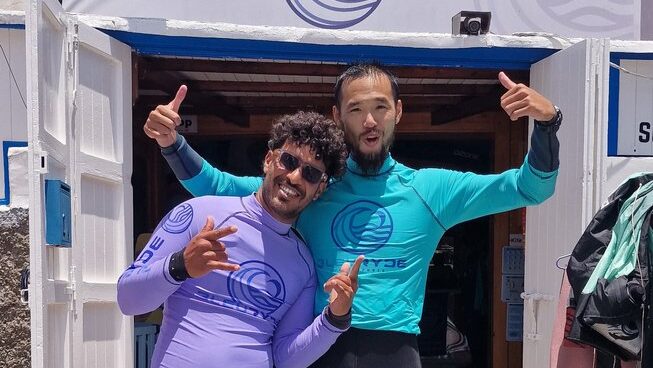 Two happy people learning how to surf at Bleuryde Watersports surf camp in Essaouira Morocco