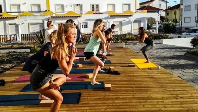 People doing yoga at Boa Onda Guesthouse surf camp in Peniche Portugal