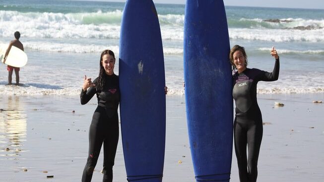 Two girls standing with their surfboard at Breath surf Camp in Agadir