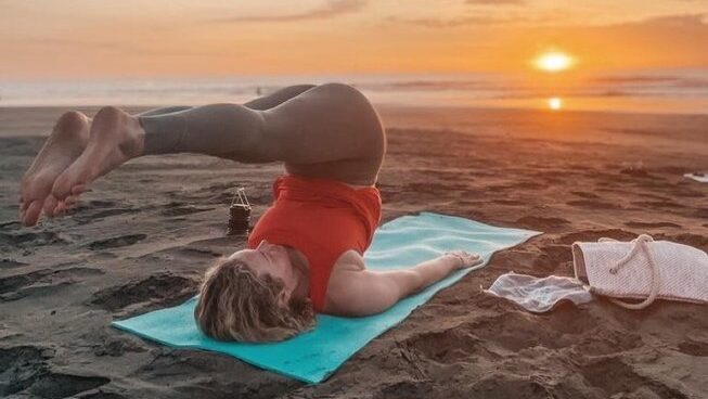 a person doing yoga at sunset at Del Alma Retreat Costa Rica surf camp
