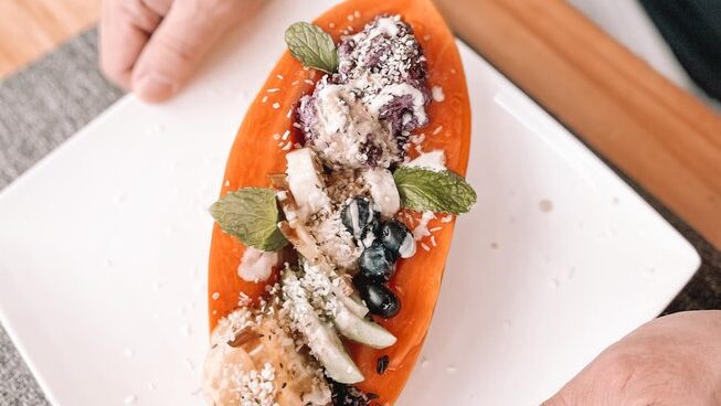 a papaya filled with food at Del Alma Retreat Costa Rica surf camp