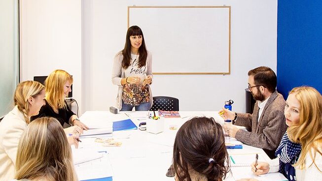 Students with a teacher learning Spanish at El Aula Azul surf camp in San Sebastian