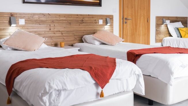 two beds at accommodation at Ferrel Surf House surf camp in Peniche Portugal
