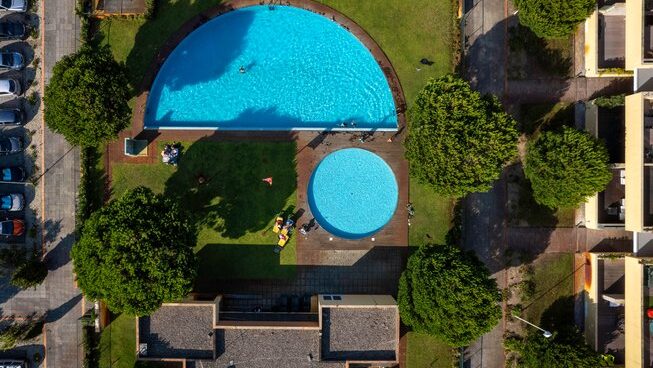 Drone shot looking down with accommodation and pool at Golden Waves Surf and Yoga Lodge surf camp Portugal