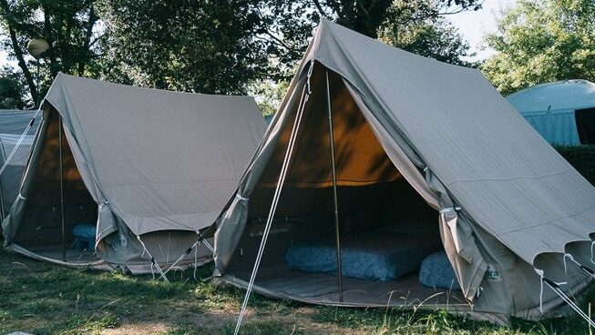 A line of tents at Good People Surf surf camp in Zarautz